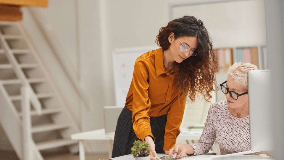 Two women laughing while working